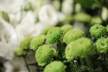 Bouquet of colorful roses and other flowers at the entry to flower shop at farmers' market