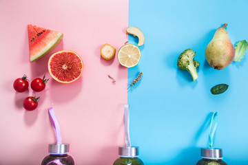 Glass bottles with natural drinks on a colored background