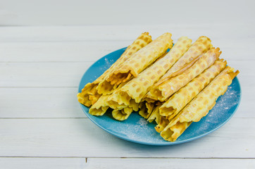 homemade waffle tubes on a blue plate