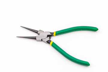 Opened combination pliers with green grasp on white background