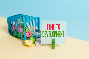 Text sign showing Time To Development. Business photo showcasing a length of time during which a company grows or develop Trash bin crumpled paper clothespin empty reminder office supplies tipped