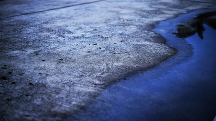 concrete road and flooding water. poor drainage system left puddle of inundated rain storm water on street surface