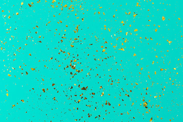 Golden sparkles on aquamarine luxury background. Abstract