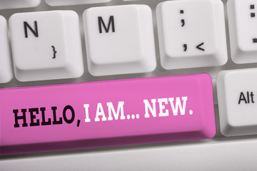Word writing text Hello I Am New. Business photo showcasing introducing oneself in a group as fresh worker or student White pc keyboard with empty note paper above white background key copy space