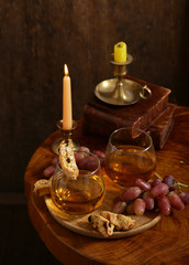 dessert white wine and biscotti on a wooden table