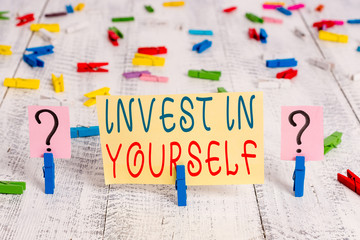Writing note showing Invest In Yourself. Business concept for learn new things or materials thus making your lot better Crumbling sheet with paper clips placed on the wooden table