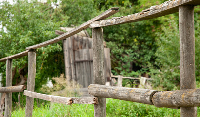 simple wooden fence around abandoned old farmhouse