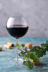 A glass with red wine. The concept of winemaking. Place under your text. Still life on a textural background.