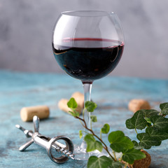 A glass with red wine. The concept of winemaking. Place under your text. Still life on a textural background.