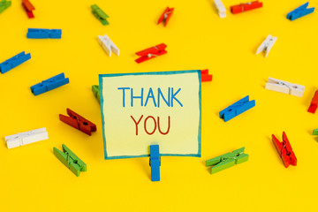 Text sign showing Thank You. Business photo text a polite expression used when acknowledging a gift or service Colored clothespin papers empty reminder yellow floor background office
