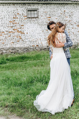 A young couple of brides have a fun and walking in the field outdoor