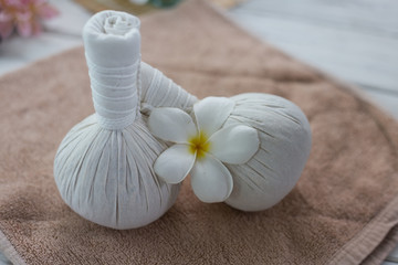 Spa herbal compressing ball with candle and orchid.