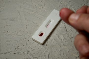 HIV self-test finger with a drop of blood. Hiv test express.