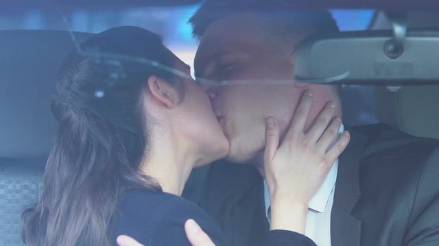 Couple in love enjoying passionate kiss in car, seduction and pick-up tips