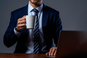 smart attractive caucasian business investor drink hot coffee use laptop with confident and cheerful