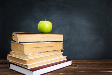 Green apple over pile of books for shool concept. Education concept, toned and soft focus image