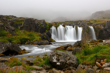 Long exposure photo of waterfall, view of the small waterfall in Westfjords of Iceland, Europe.