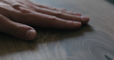 Fototapeta premium closeup man hand checking untrated black walnut solid board