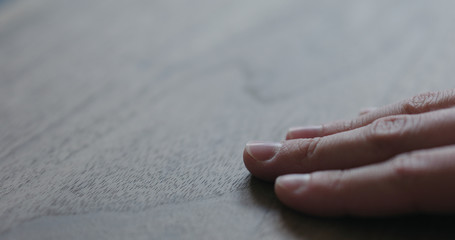 closeup man hand checking untrated black walnut solid board