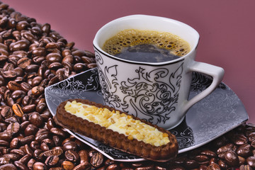 Cup of coffee with beans and cookies