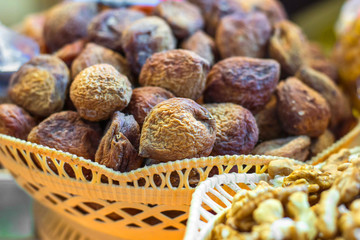 Exotic dried fruits close-up in a wicker basket.