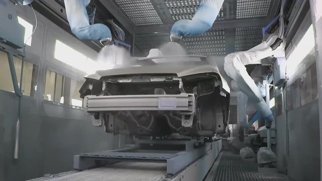 Industrial robots paint the car body