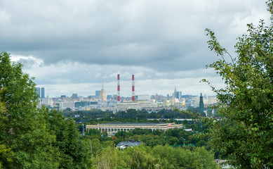 view from Sparrow hills to the Ostankino TV tower, Russian government building, two soviet skyscrapers and power station with smoking pipes