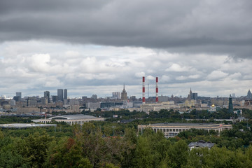 view from Sparrow hills to the Ostankino TV tower, Russian government building, two soviet skyscrapers and power station with smoking pipes