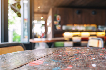 Wooden table and chairs with blurred background in cafe
