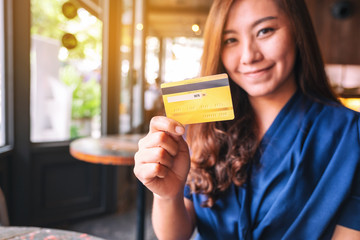 A beautiful asian woman holding credit card for shopping