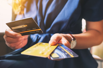 Closeup image of a woman holding and showing credit card