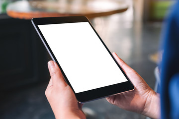 Mockup image of a woman holding black tablet pc with blank white desktop screen