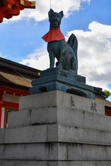 Bronze statue of fox god with the key in his mouth at Fushimi Inari Taisha Shinto shrine, Kyoto, Japan