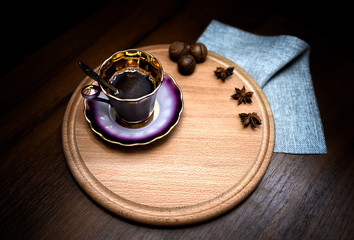 Cup of coffee with milk on a dark background. Hot latte or Cappuccino prepared with milk on a wooden table with copy space  for text. Selective focus