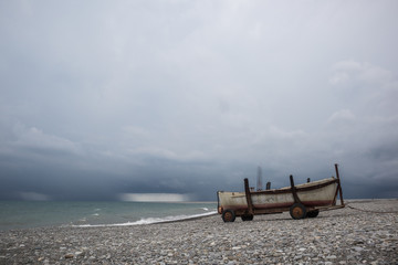 Fototapeta na wymiar Boat on the beach by the sea