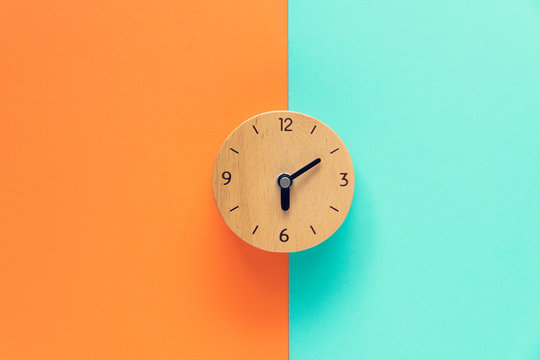 Retro alarm clock on color table, vintage style on the good morning concept