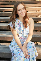 woman in the park sits on the stairs