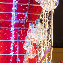 Christmas lanterns in the form of lamps and tinsel close-up