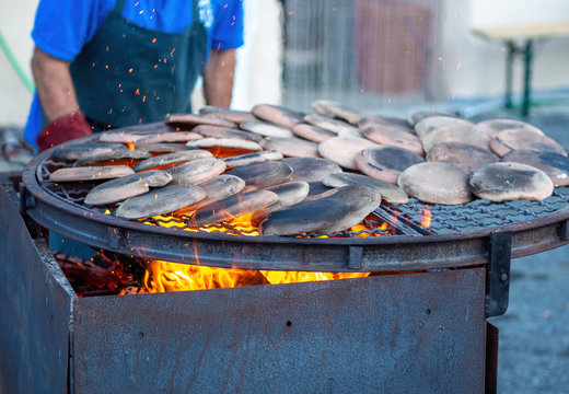 Preparing to cook Panigacci, a speciality flat bread from Lunigiana, north Tuscany, Italy. Here, heating the testi - testo ie terracotta moulds.