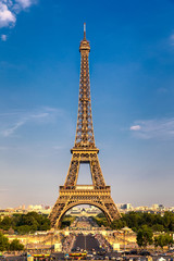 Eiffel tower in summer, Paris, France. Scenic panorama of the Eiffel tower under the blue sky. View of the Eiffel Tower in Paris, France in a beautiful summer day. Paris, France.