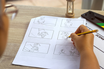Storyboard drawing with pencil creative sketch cartoon. Storyboarding is process image displayed in sequence for purpose of pre-visualizing motion picture, interactive media. Concept sketching ideas.