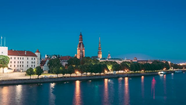 Riga, Latvia, Europe. Cityscape Skyline In Evening Time. Night View Of Castle, Dome Cathedral And St. Peter's Church. Popular Place With Famous Landmarks. UNESCO world heritage site