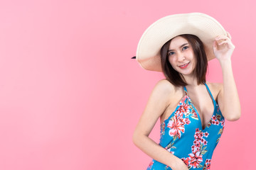 eautiful,Sexy asian girl standing on pink background in a colors bathing suit bikini and smiling.concept style vogue
