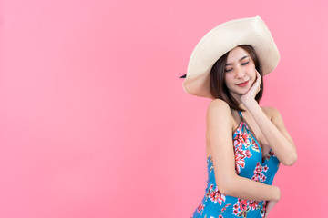 eautiful,Sexy asian girl standing on pink background in a colors bathing suit bikini and smiling.concept style vogue