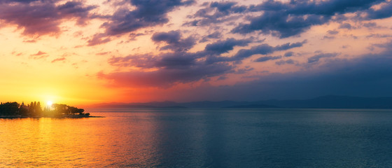 Fototapeta premium Beautiful sunset or sunrise above the sea. Tropical sunset or sunrise over sea. Colourful sunset or sunrise over water.