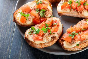 Appetizer bruschetta with tuna, mozarella cheese and tomatoes