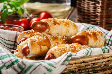 Rolled hot dog sausages baked in puff pastry