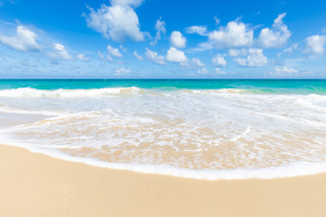 Tropical sea beach white wave against blue sky cloud