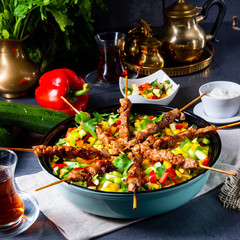 Lamb skewers with curry rice and different vegetables