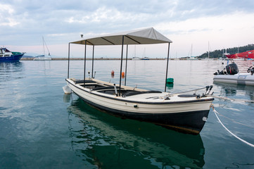 Naklejka na ściany i meble Fishing boat in a small seaport